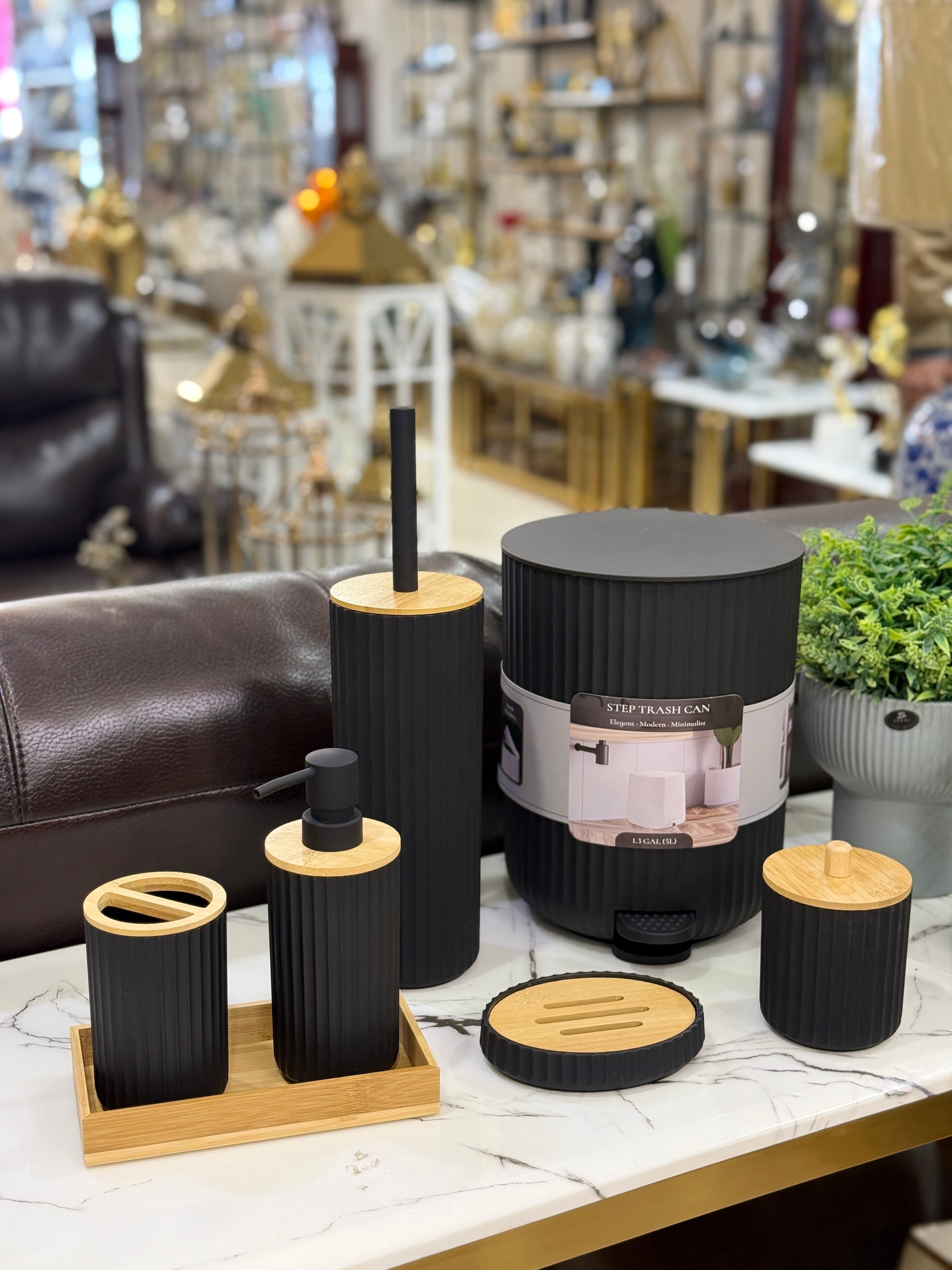 7-piece minimalist matte black ribbed bathroom accessory set including a trash can, soap dispenser, and bamboo tray at Fatima Home Décor store in Islamabad