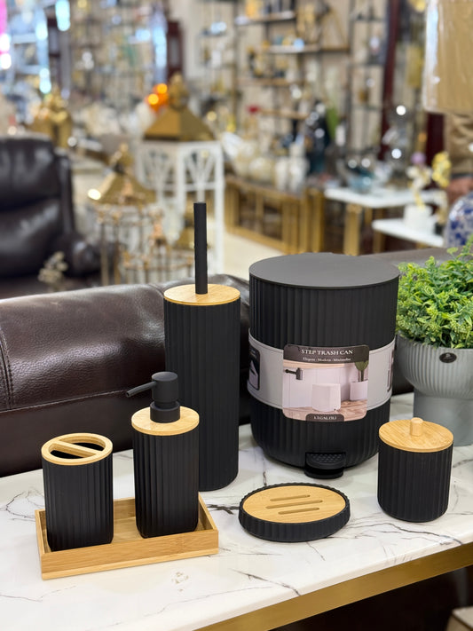 7-piece minimalist matte black ribbed bathroom accessory set including a trash can, soap dispenser, and bamboo tray at Fatima Home Décor store in Islamabad