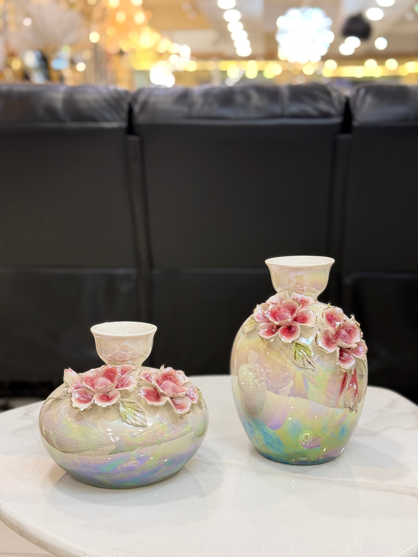 Set of two iridescent pearlescent ceramic vases with hand-sculpted 3D pink roses and green leaves at Fatima Home Décor store in Islamabad.