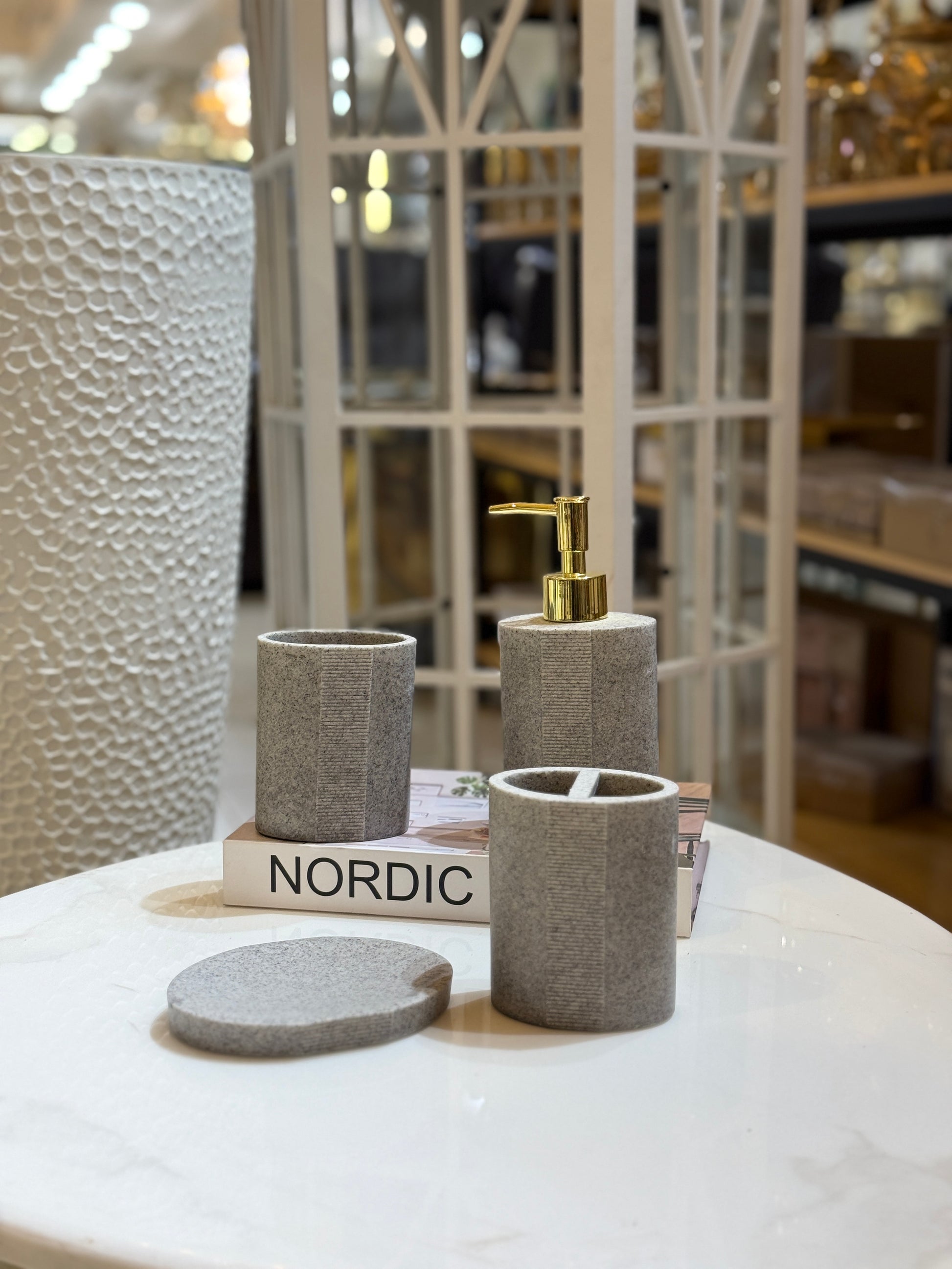 Nordic style 4-piece granite grey bathroom accessory set with gold pump and vertical ribbed texture on a marble surface at Fatima Home Decor store.
