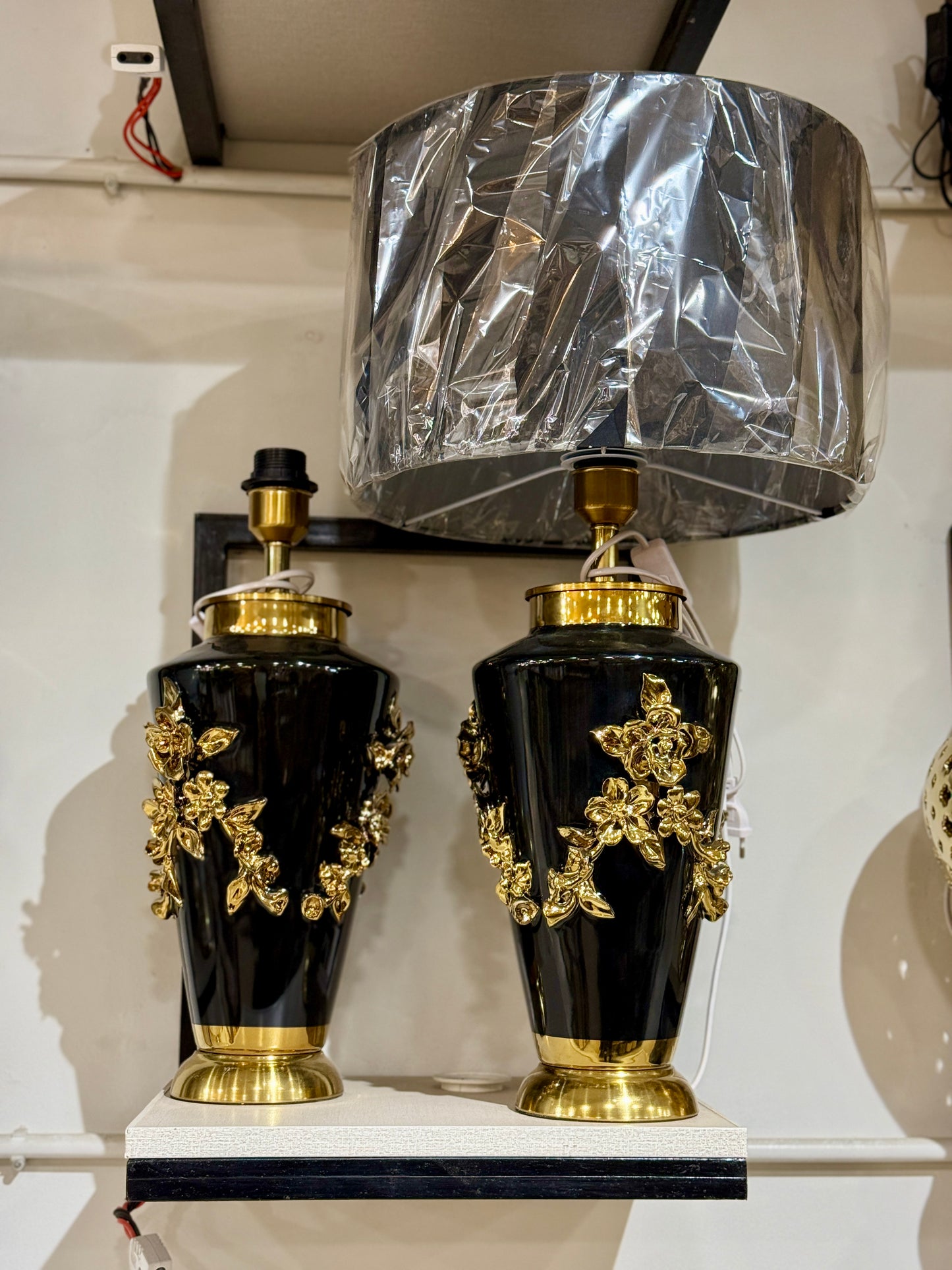 Luxury table lamp with a black ceramic urn base, 3D golden rose vines, and a large drum shade at Fatima Home Decor store in Islamabad.