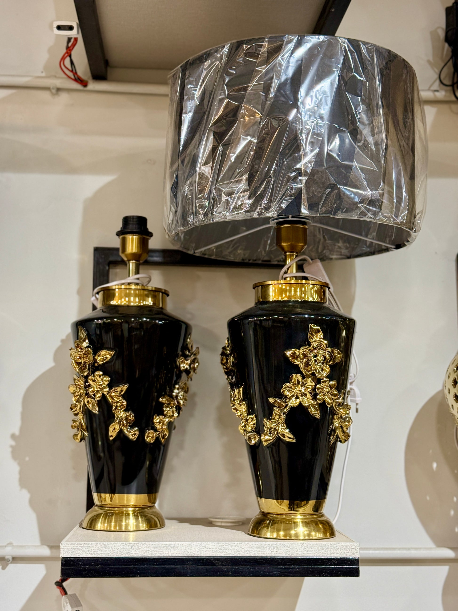 Luxury table lamp with a black ceramic urn base, 3D golden rose vines, and a large drum shade at Fatima Home Decor store in Islamabad.